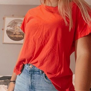 Pinkish red athletic shirt with slit in back